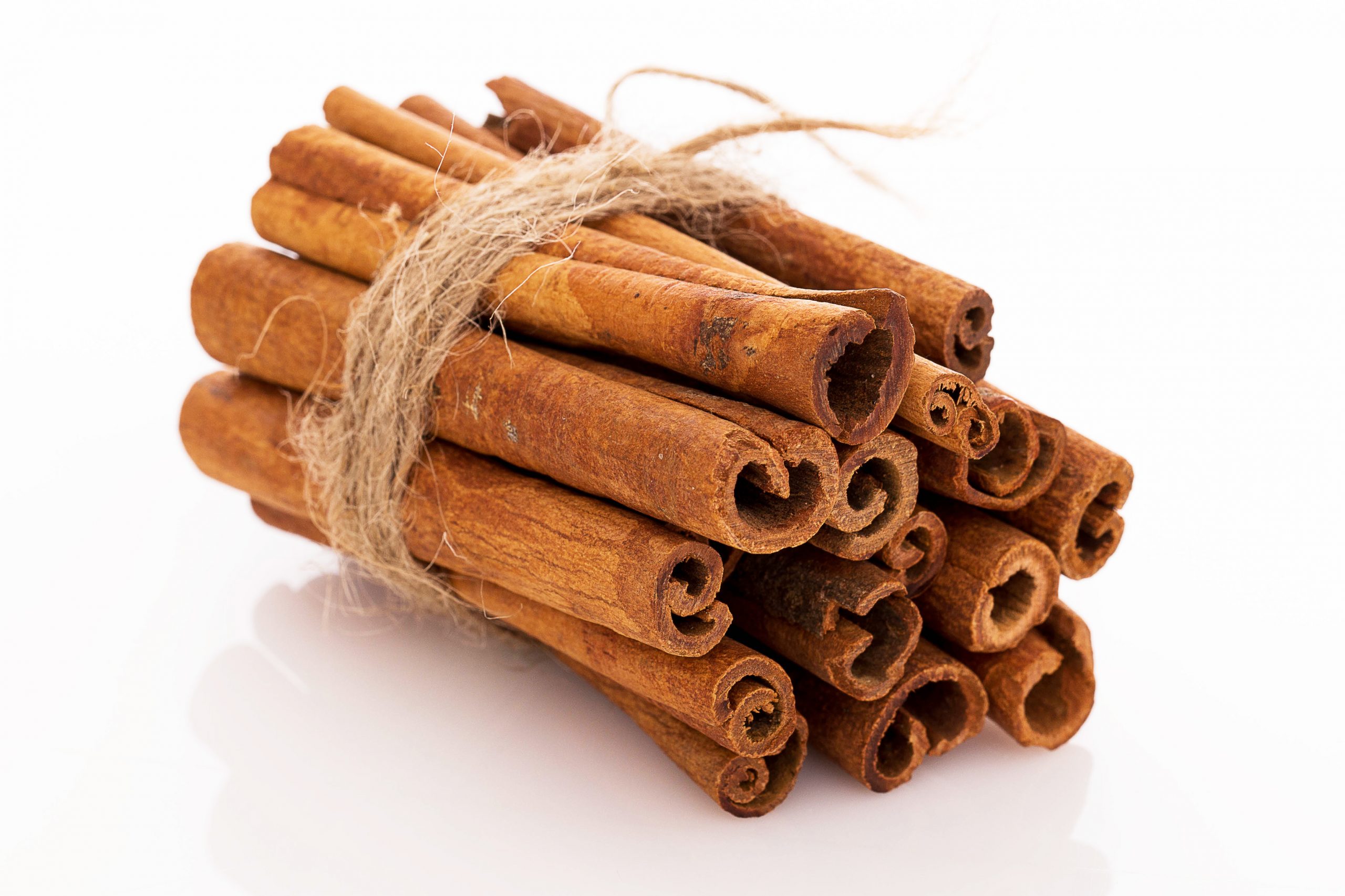 Stack of cinnamon over a white background